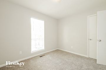Trussville house for rent - a bedroom with white walls and carpet and a door