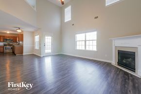 Mcdonough house for rent - A spacious living room with wood flooring and a fireplace.
