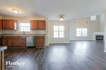 Mcdonough house for rent - A spacious kitchen with wooden cabinets and a stainless steel refrigerator.