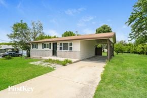 Saint Charles house for rent - A house with a brown roof and a garage door is for sale.
