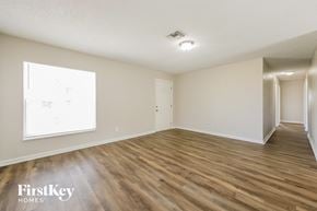 Port Charlotte house for rent - a spacious living room with hardwood flooring and a window