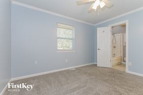Belton house for rent - a bedroom with blue walls and a white door to a bathroom