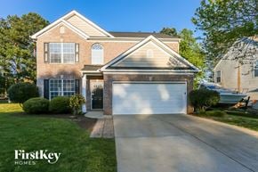 Mooresville house for rent - a home with a white garage door in front of it