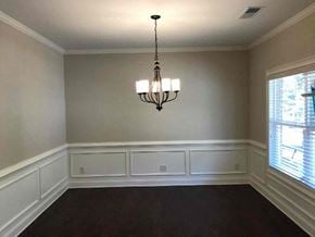 Newnan house for rent - a empty dining room with a chandelier and a window