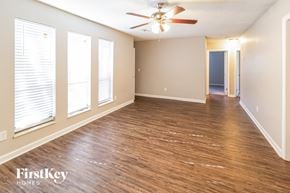 Summerville house for rent - the living room and dining room with wood flooring and a ceiling fan