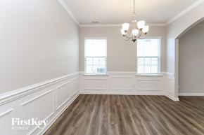 Mooresville house for rent - A room with wooden floors and a chandelier.