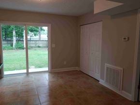 North Charleston house for rent - A room with a sliding glass door leading to a backyard.