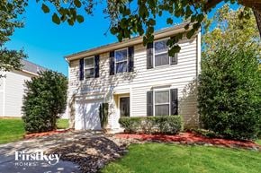 Mooresville house for rent - a white house with a sidewalk in front of a yard