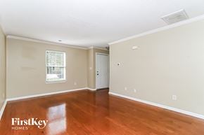 Mooresville house for rent - the living room of a house with wood floors and white walls