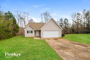 Covington house for rent - the front of a white house with a dirt driveway