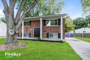 Florissant house for rent - A brick house with a tree in front of it.