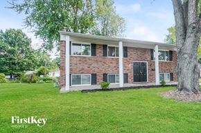 Florissant house for rent - A brick house with a tree in front of it.