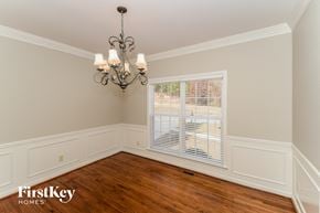 Helena house for rent - a dining room with wood floors and a large window