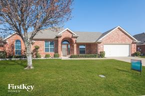 Forney house for rent - a house with a lawn and a tree in front of it