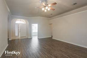 Forney house for rent - the living room of an empty house with a ceiling fan