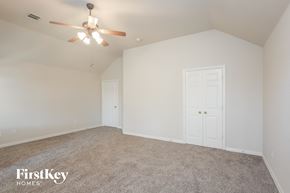 Forney house for rent - a bedroom with white walls and carpet and a ceiling fan