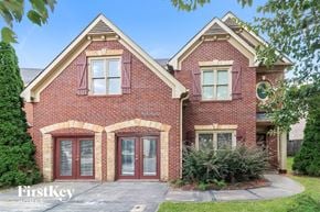 Mcdonough house for rent - front view of a brick house with red doors