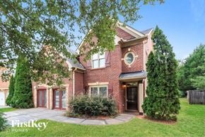Mcdonough house for rent - the front of a brick house with a yard and trees