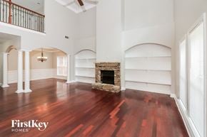 Mcdonough house for rent - a living room with a fireplace and wooden floors