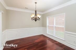 Mcdonough house for rent - a dining room with a large window and a chandelier
