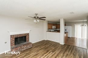 Arlington house for rent - A living room with a fireplace and a ceiling fan.