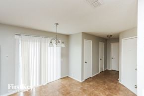 Arlington house for rent - A room with a chandelier, a window with curtains, and a tiled floor.