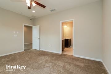 St. Augustine house for rent - a living room with carpet and a ceiling fan