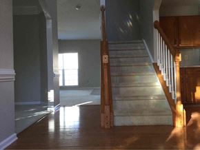 Mooresville house for rent - A wooden staircase with a light shining on the floor.