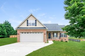 Clemmons house for rent - a brick house with a white garage door
