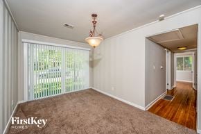 Birmingham house for rent - A room with a carpeted floor and a sliding glass door.