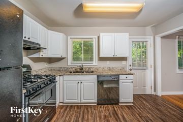 Birmingham house for rent - A kitchen with white cabinets and a granite countertop.