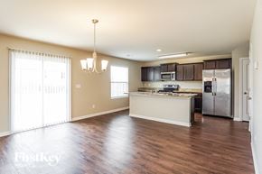 Calera house for rent - an empty kitchen with a stainless steel refrigerator