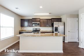 Calera house for rent - a kitchen with a counter top and a refrigerator