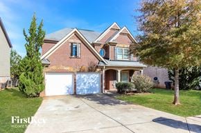 Mcdonough house for rent - a brick house with a garage and a white garage door