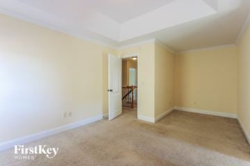 Mcdonough house for rent - a living room with carpet and a door to a hallway
