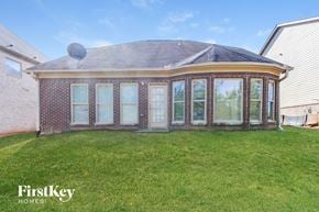 Mcdonough house for rent - the front of a brick house with a yard and grass