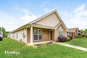 Calera house for rent - A house with a brown roof and a white door is shown.