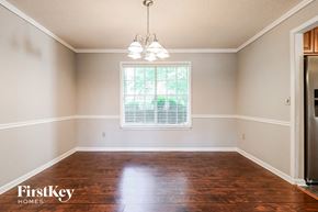 Loganville house for rent - a empty dining room with wood floors and a window