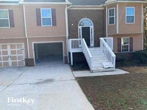 Covington house for rent - a house with a white porch and a driveway