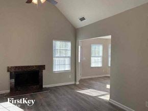 Covington house for rent - an empty living room with a fireplace