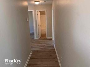 Covington house for rent - a hallway with white walls and a wooden floor