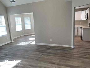 Covington house for rent - an empty living room with a hard wood floor
