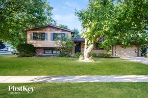 Crystal Lake house for rent - A house with a brown roof and a tree in front of it.