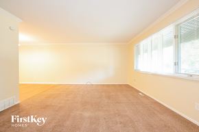 Crystal Lake house for rent - A room with a carpeted floor and a window with blinds.