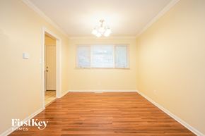 Crystal Lake house for rent - A room with wooden floors and a window with blinds.