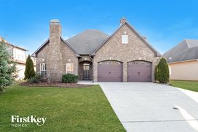 Wilsonville house for rent - a large brick house with purple garage doors