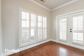 Wilsonville house for rent - a living room with wood floors and white plantation shuttered windows