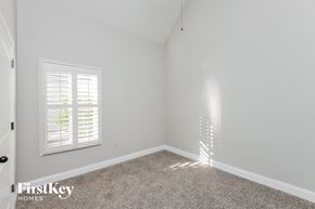Wilsonville house for rent - a bedroom with white walls and carpet and a window