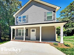 Concord house for rent - A house with a grey siding and a white door is for sale by FirstKey Homes.