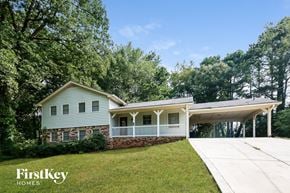 Lawrenceville house for rent - a white and blue house with a lawn and trees